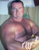 hunky stocky daddybear flexing thick biceps.jpg