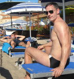 wet man sitting beach chairs suntanning ocean.jpg