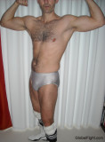 muscle studly wrestler flexing arms posing hairypecs.jpg