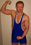 redhead wrestler jock flexing biceps wearing singlets.jpg