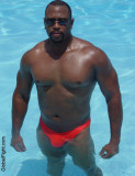 super hot black man swimming glistening ebony muscles.jpg