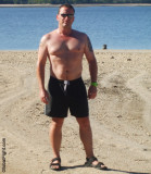 hot hunky bearish man beach ocean resort suntanning pics.jpg