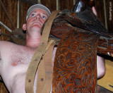 shirtless cowboy carrying saddle western wear pics.jpg
