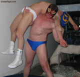pro wrestling man carrying helpless wrestler knockedout.jpg