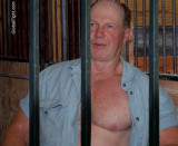 shirtless man prison rodeo torn shirt horse stalls.jpg