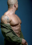 muscleman removing shirt tattoos on arm bicep.jpg