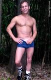 muscular handsome jock pulling down pants shorts.jpg