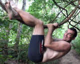 hairy man hanging on tree branch shirtless beach pics.jpg