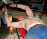 man working on car draining radiator oil fluids.jpg
