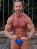 moustache bodybuilder flexing beach water park.jpg