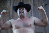 cowboy standing barn yard pasture sweaty.jpg