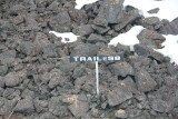 Sign indicating where the original foot trail was that prospectors used before the railroad was completed.