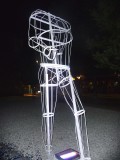 A solitary white sculpture in the shape of a human torso.
