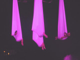 The women were enveloped in the cloth like they were in hammocks.