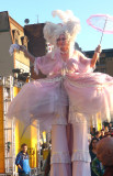 A leopard-clad woman on stilts who looked like an antebellum southern belle.