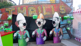 A Thrills sign which had cute cartoon-like figures in front of it.