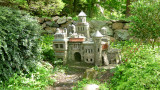 A miniature stone castle off of one of the gardens.
