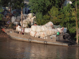 LOADING BOAT WITH VILLAGE RUBBISH