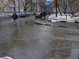 Puddle on street in downtown Moscow during spring thaw