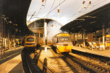 Class 43047 ROTHERHAM ENTERPRISE pulls away from Newcastle, while the rear of 43067 is in the platfom - Nov 1990.