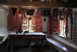 Interior of the Shevchenko family house with red and white curtains, Middle Dnipro Region, Pyrohiv
