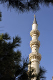 Minaret, pines and blue sky