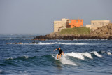 Surfer with the Cap-Verte coast of Ngor in the background