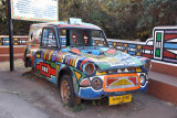 A wrecked car colorfully painted at Lesedi Cultural Village