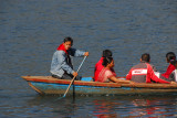 Canoeist paddling tourists on Lake Phewa