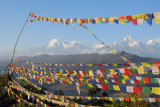 Buddhist prayer flags with the Annapurnas, ridge near World Peace Pagoda