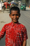 Boy in a red shirt along the road to Dhaka in Fatulla