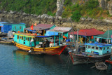 Fishing boats tied up at a floating village, Halong Bay