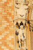 Sculpture of a soldier wearing only a helment, to the left of the central balcony on the west faade, Doges Palace