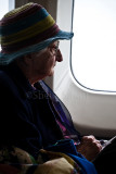 Elderly lady looking out window on Manly ferry