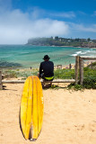 Man with surfboard at North Avalon Beach, Sydney