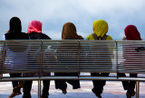Five girls in hijab on bench