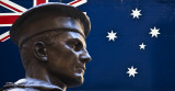 Australian flag with statue of soldier at Cenataph
