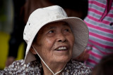 Elderly Asian lady in hat 