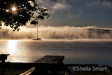 Two yachts in rolling dawn mist