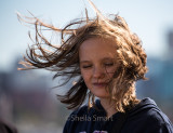 Girl with hair blowing in wind on ferry 