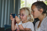 Molly showing Charli how to use my mobile phone