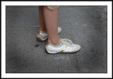 Kim treatened pointy shoes, but shows up in gold layered sneakers.