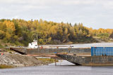 Barges docked in front of fall foliage