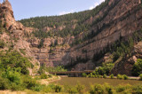 I-70 in Glenwood Canyon passing into the tunnels above a railway and the Colorado River