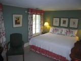 Room 2,  Decorated in shades of rose and green, this colorful room features a king bed,