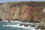 cliffs on north side of Hanover cove showing modern mining operations through the metaliferous sandstones