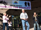 Chico Mayor Andy Holcombe (center) speaks,  as Vice Mayor Anne Schwab (left) and former Mayor Scott Gruendl (right) applaud