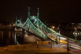 Liberty Bridge and a moving yellow tram - Budapest, Hungary