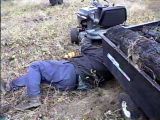 Dad putting drivebelt back on tractor after getting it stuck going up steep terrain with trailer being overloaded.jpg