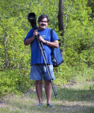 Felipe carrying heavy lens & tripod
